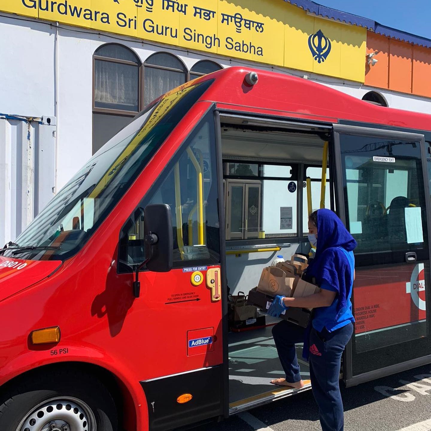 A person entering a bus carrying food