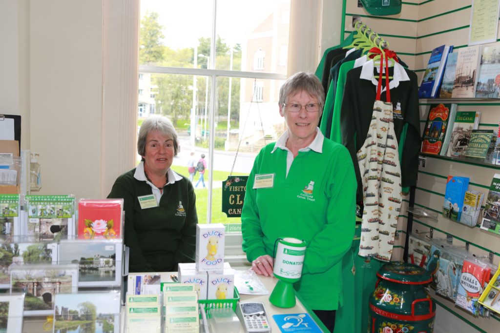 Two volunteers pictured in the Cotswold Canals Trust shop.